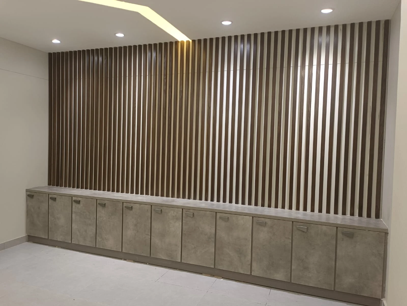 Slatted wall finish and fitted storage shown in the Steed Art company profile