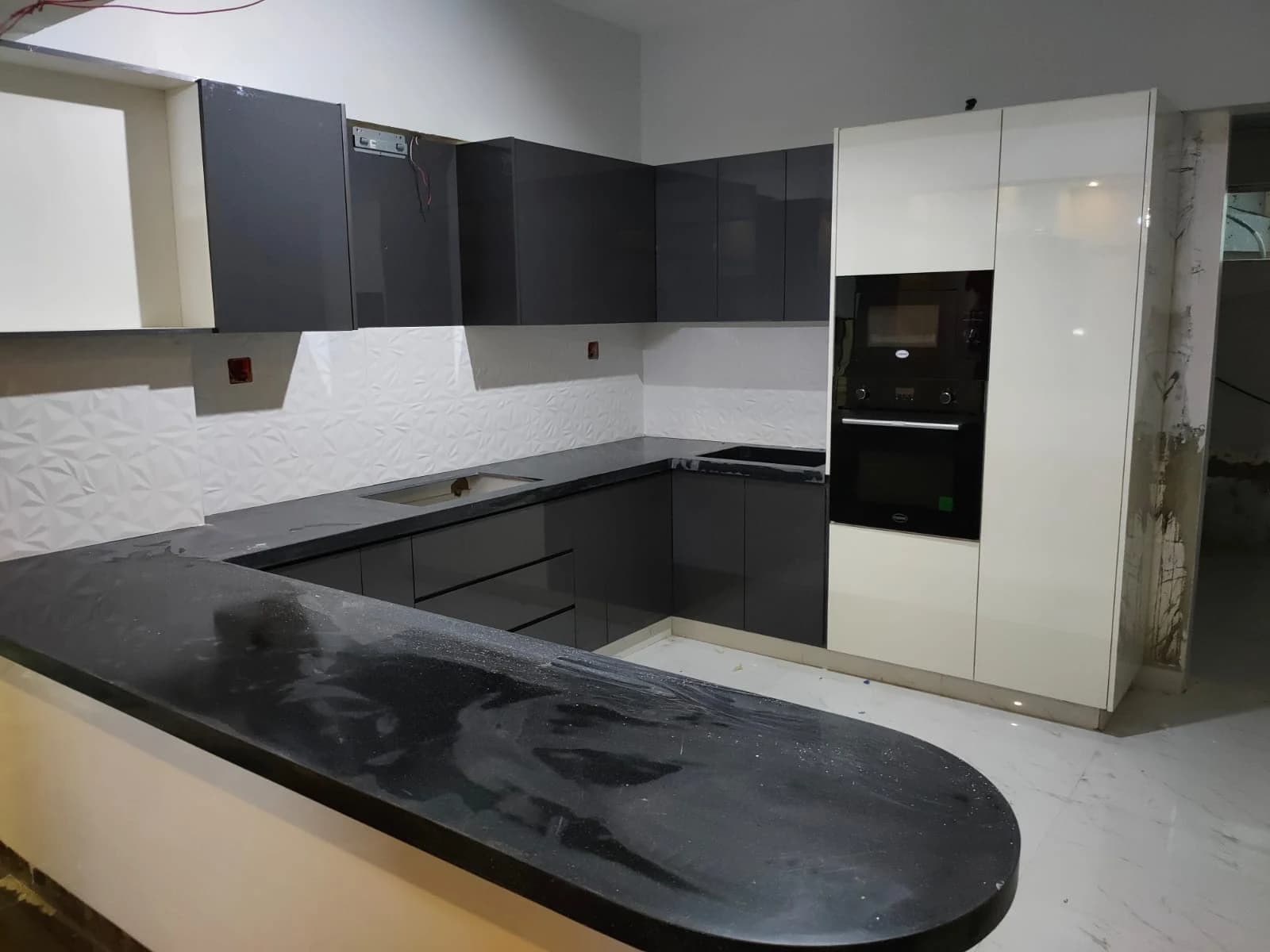 Dark kitchen cabinetry and lighter upper units from the Steed Art company profile